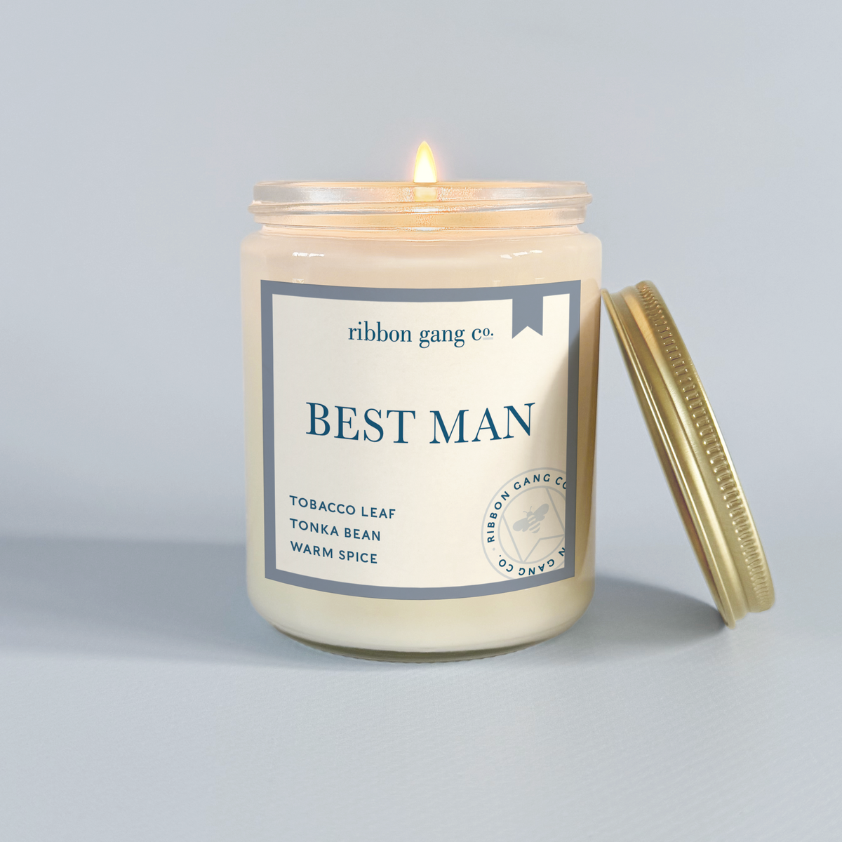 Candle with 'Best Man' label from Ribbon Gang Co. on a gray background.