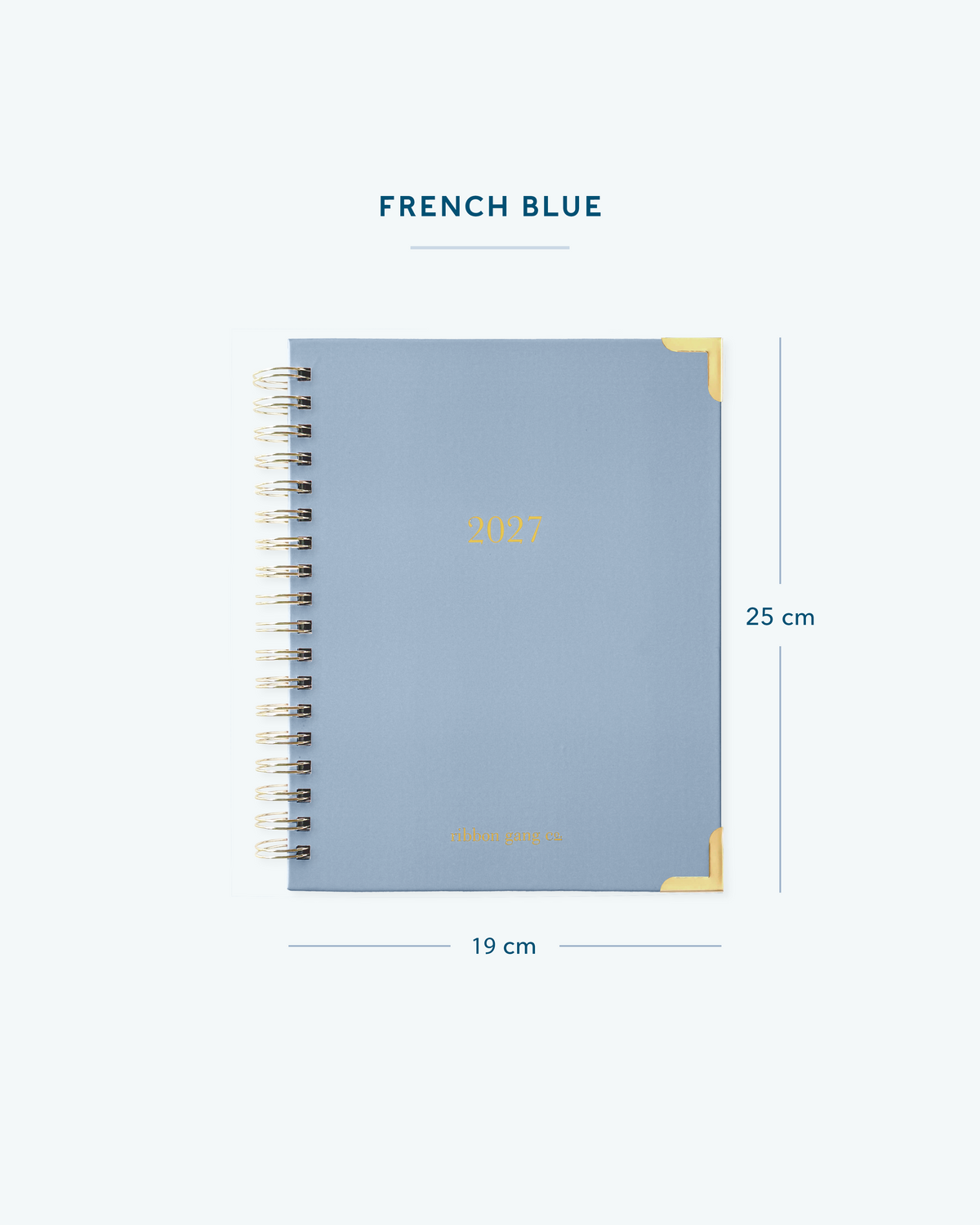 A French blue spiral bound 2027 planner with gold lettering and gold corners on a white background showing dimensions of 25 cm high and 19 cm wide.