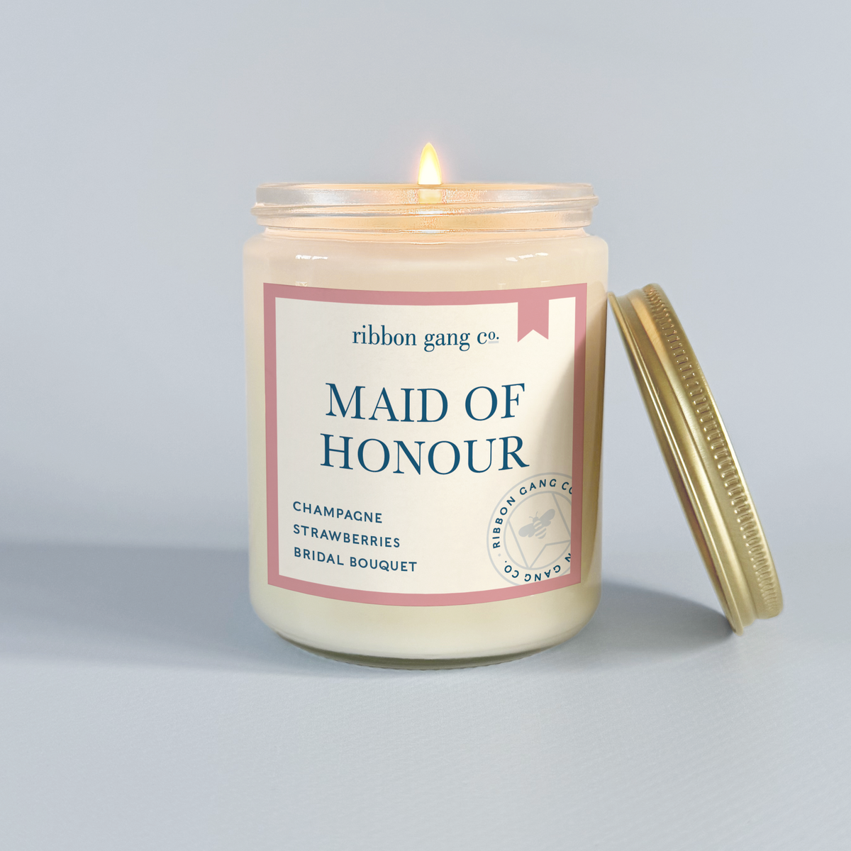 Candle with 'Maid Of Honour' label from Ribbon Gang Co. on a light gray background.